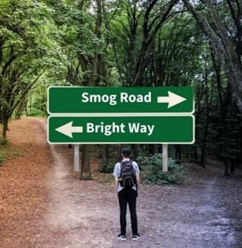 A person standing in front of two street signs.