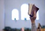 A person holding up a book in the air